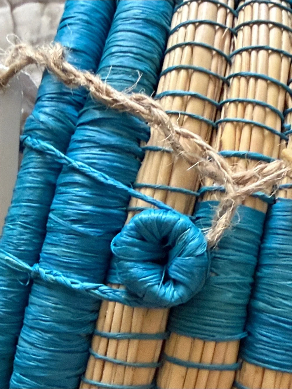 Handmade turquoise and tan coveted basket from Uganda clasp in the front